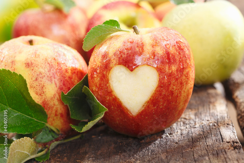 Fresh red apple with heart cutout photo