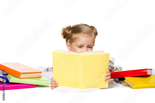 beautiful little girl reading the book