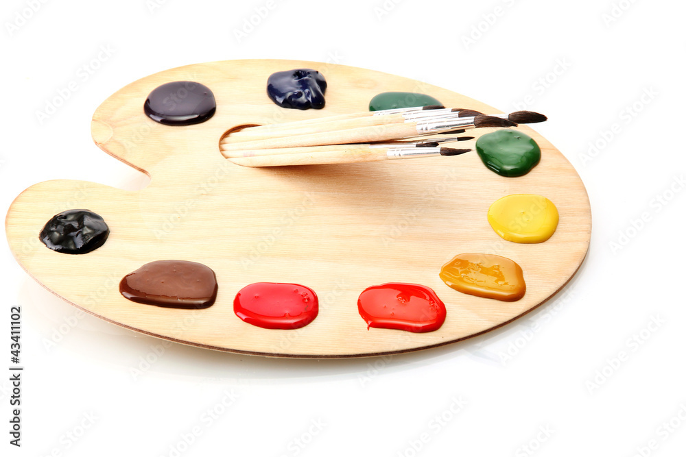 wooden art palette with paint and brushes.isolated on white wooden art palette with paint and brushes.isolated on white