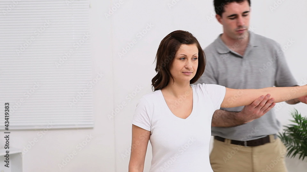 Physiotherapist working on the arm of a patient Physiotherapist working on the arm of a patient