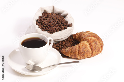 cup of hot coffee with croissants