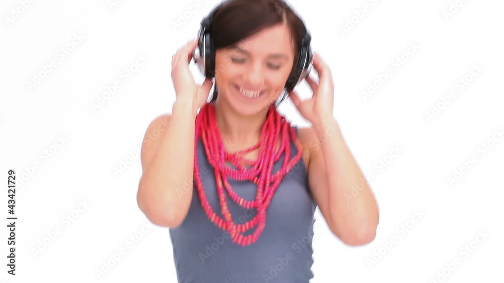 Woman dancing with her hands on her headphone Woman dancing with her hands on her headphone