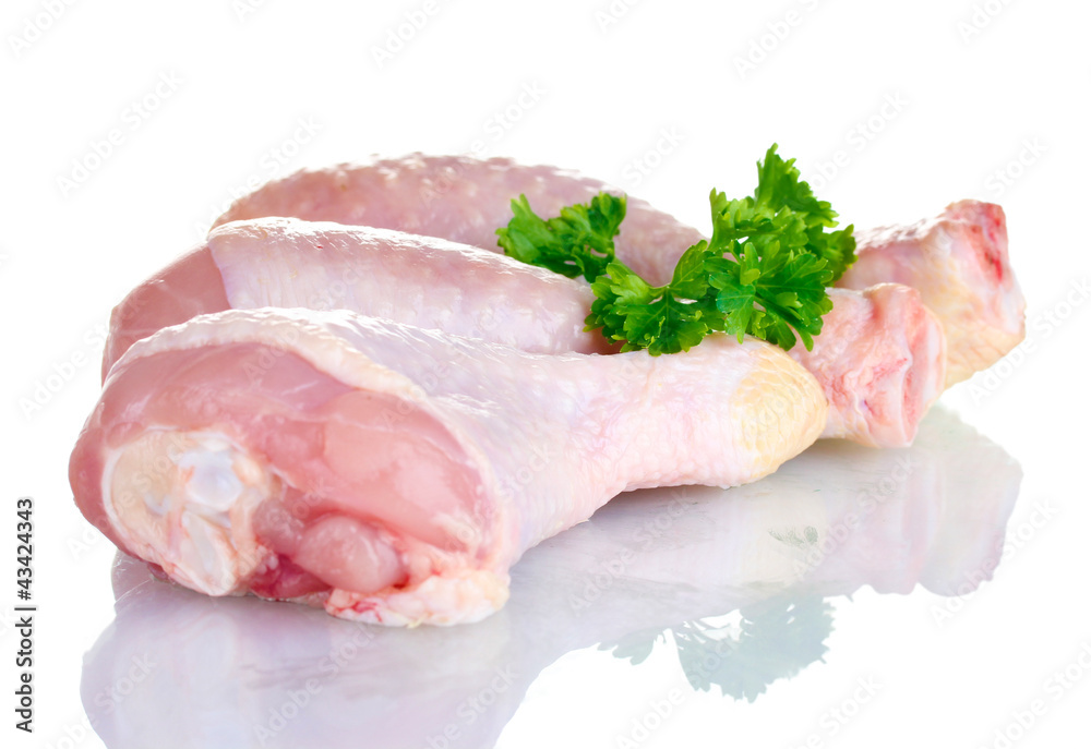 Raw Chicken Drumsticks in plate with parsley isolated on white Raw Chicken Drumsticks in plate with parsley isolated on white