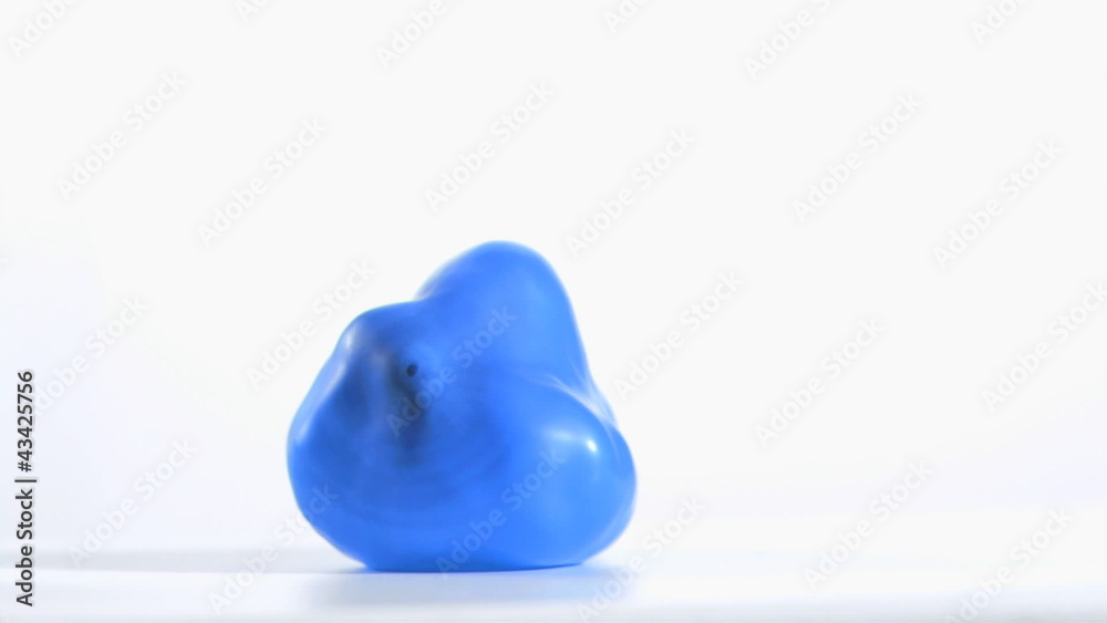 Blue balloon rebounding in super slow motion
