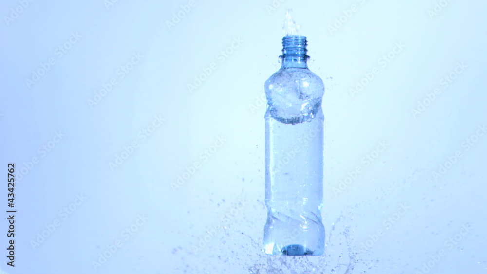 Bottle of water falling in super slow motion in surface water