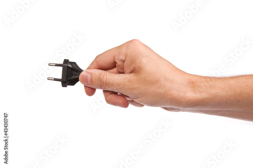 Man is holding a black outlet in the hand