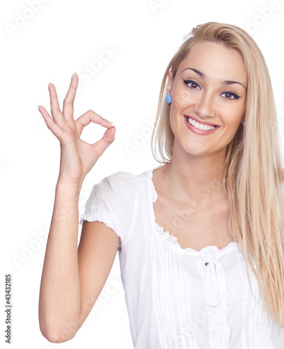 Close-up of a young woman gesturing to approve against, isolated