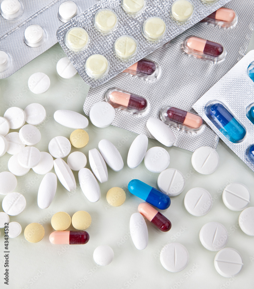 Lots of pills in their containers Lots of pills in their containers