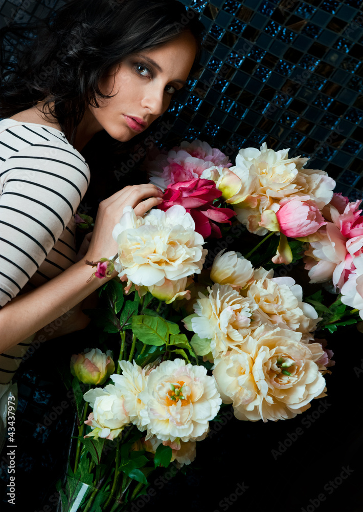Portrait of young gorgeous woman with flowers at dark room with Portrait of young gorgeous woman with flowers at dark room with