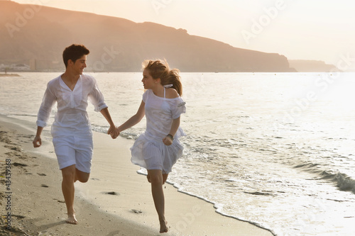 Happy young couple together on the beach