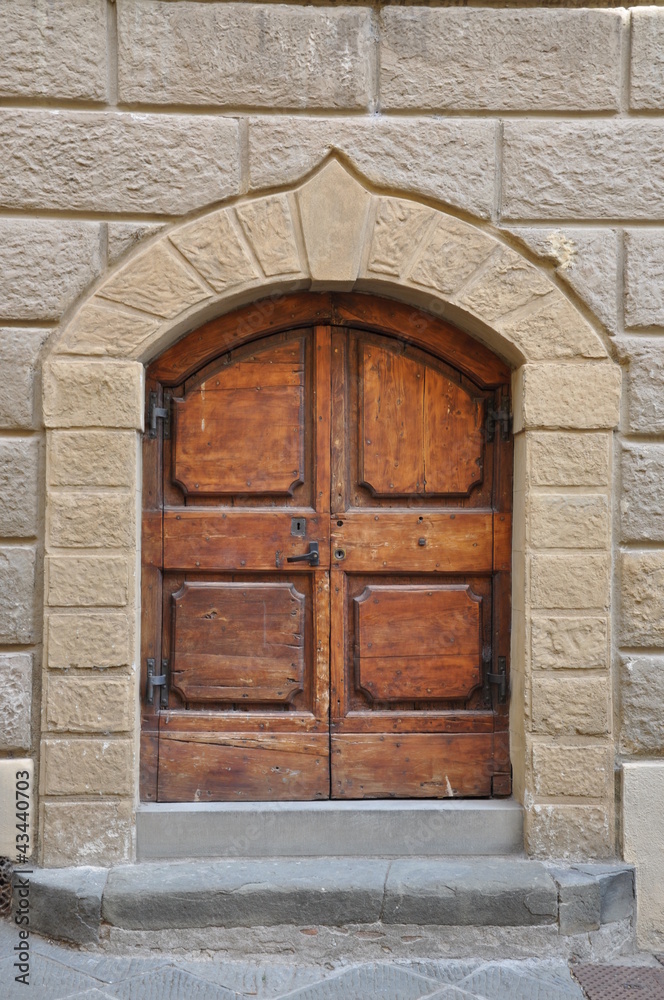 Wooden gate and a stone wall, buildings Tuscany Wooden gate and a stone wall, buildings Tuscany