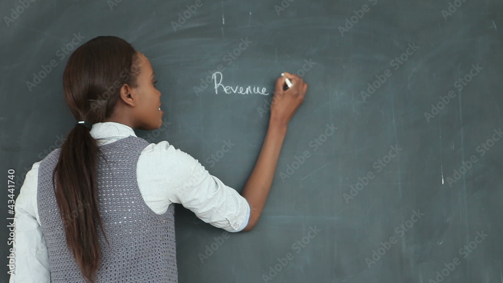 Video of a teacher smiling while using a chalk Video of a teacher smiling while using a chalk
