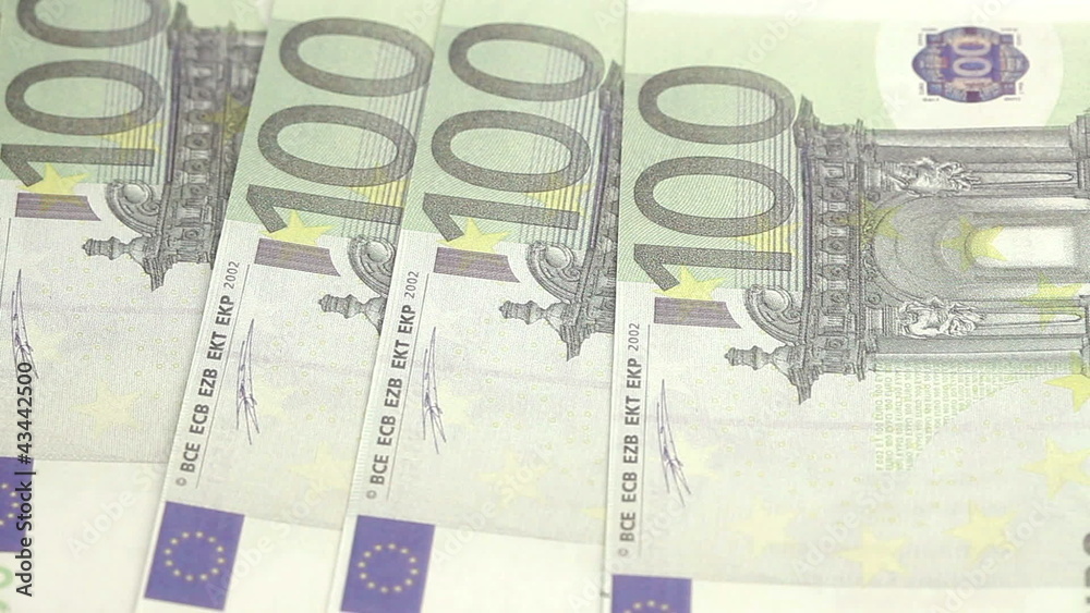 Euro bills displayed by a hand on a table Euro bills displayed by a hand on a table