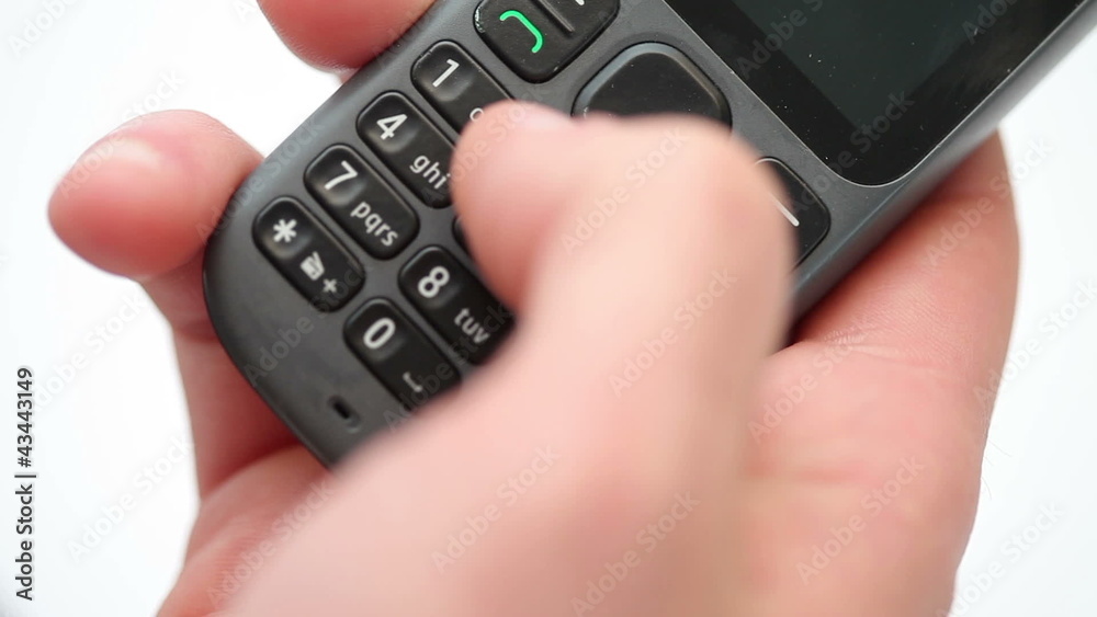 Person dialing a number on a mobile phone Person dialing a number on a mobile phone