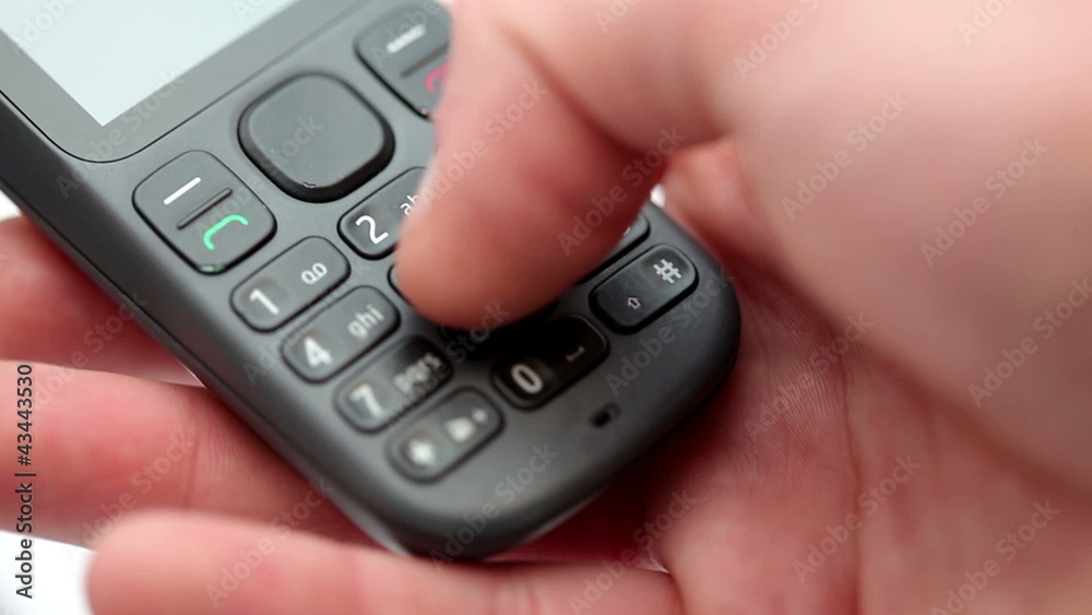 Hand dialing a number on a mobile telephone Hand dialing a number on a mobile telephone