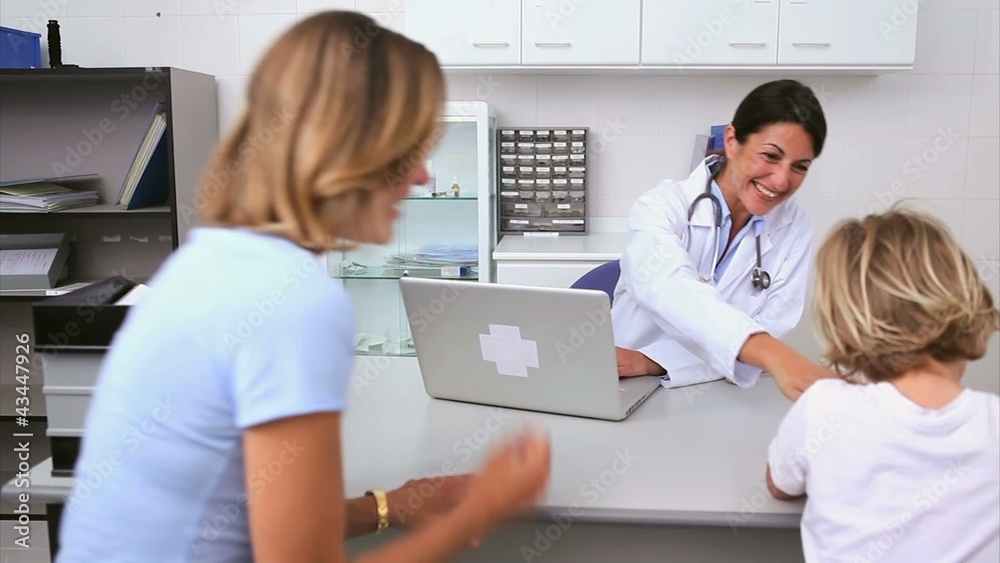 Smiling doctor in her office with patient