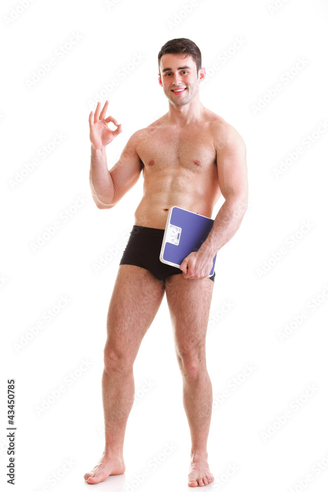Healthy young man with a weight scale Isolated Healthy young man with a weight scale Isolated