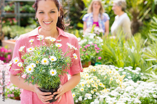 Woman shopping for flowers at garden centre