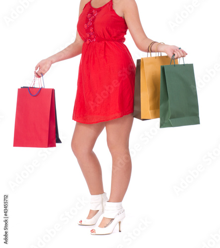 Portrait of stunning young woman carrying shopping bags