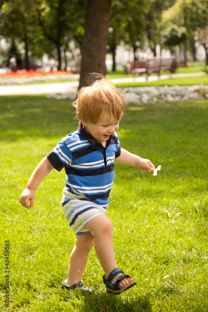 happy little boy running in garden with mouth open happy little boy running in garden with mouth open