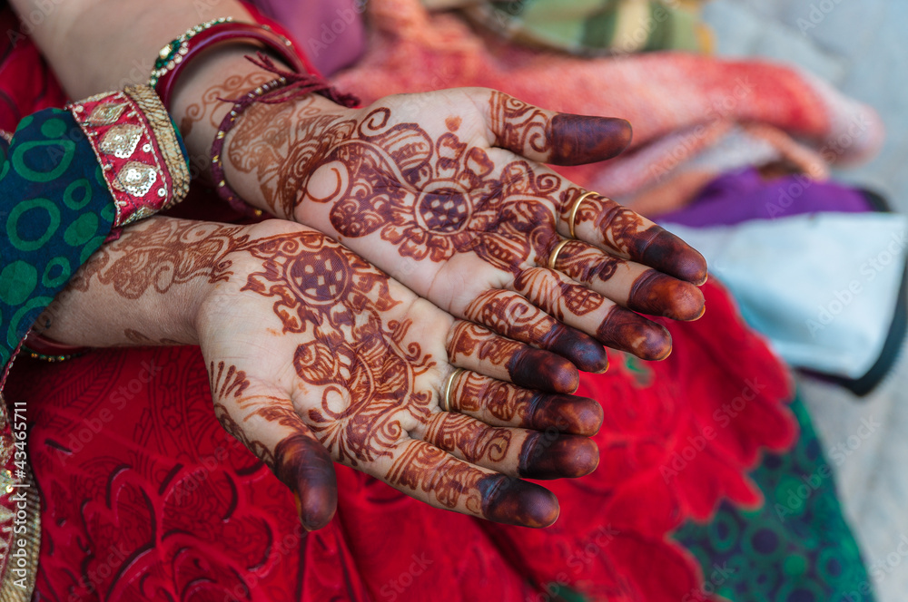 An Indian woman with henna tattoos on the hands, India