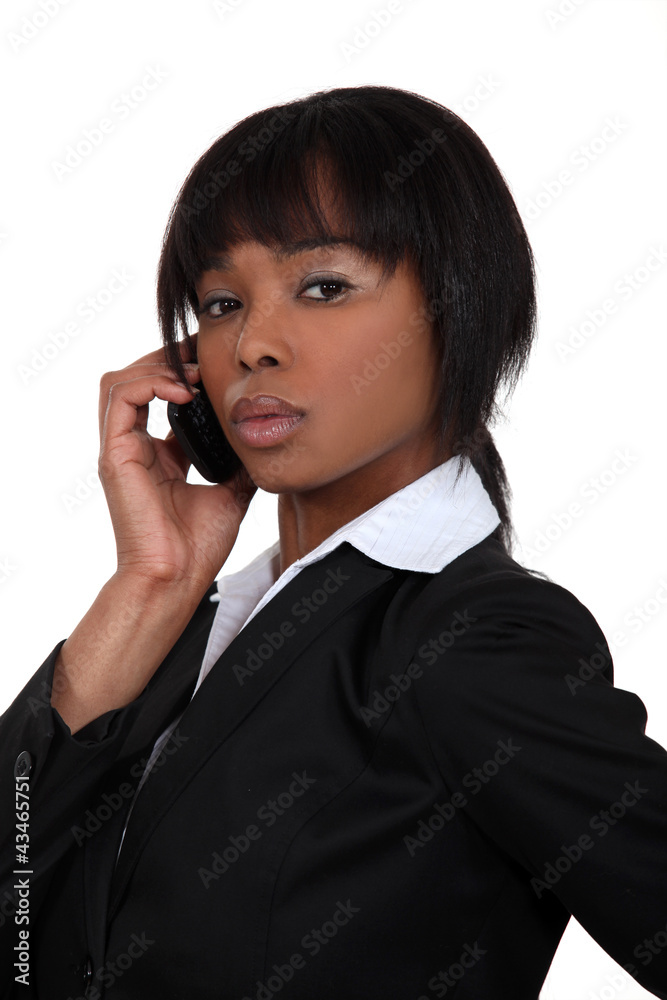 Serious businesswoman with a phone Serious businesswoman with a phone