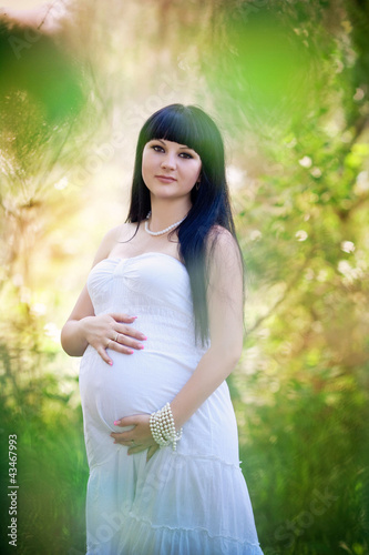 Young pregnant woman smiling posing outdoor