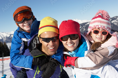 Family Having Fun On Ski Holiday In Mountains