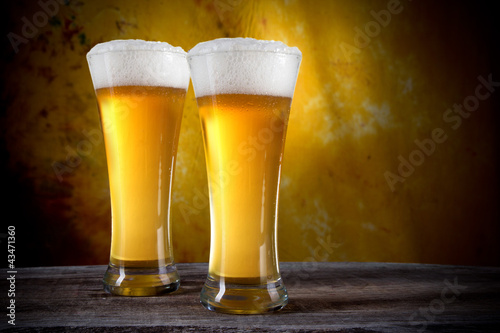 Beer in a glasses with gold background