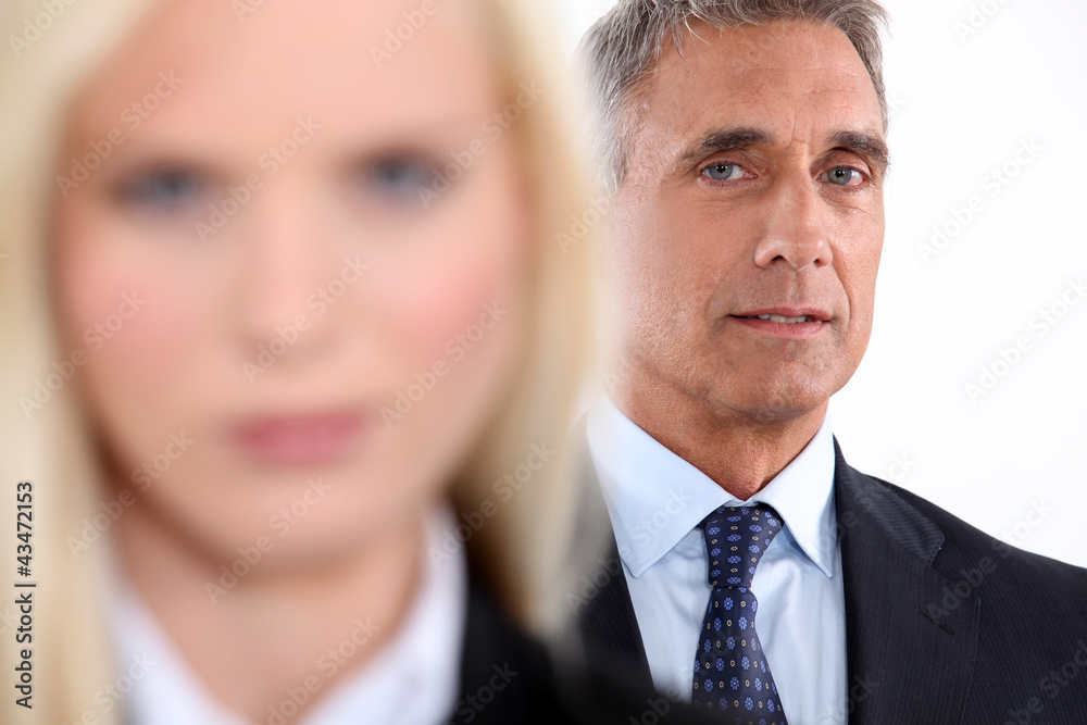 Male executive with female colleague out of focus Male executive with female colleague out of focus
