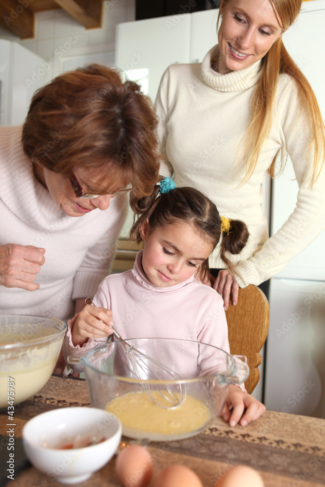 Little girl baking with her mother and grandma Little girl baking with her mother and grandma