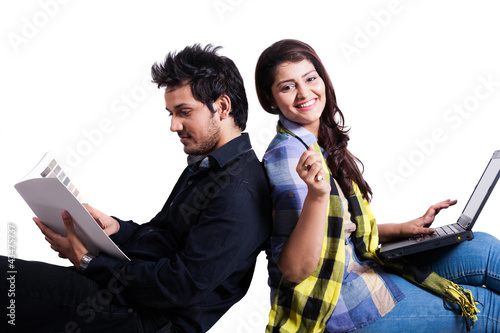 happy young couple using laptop isolated on white