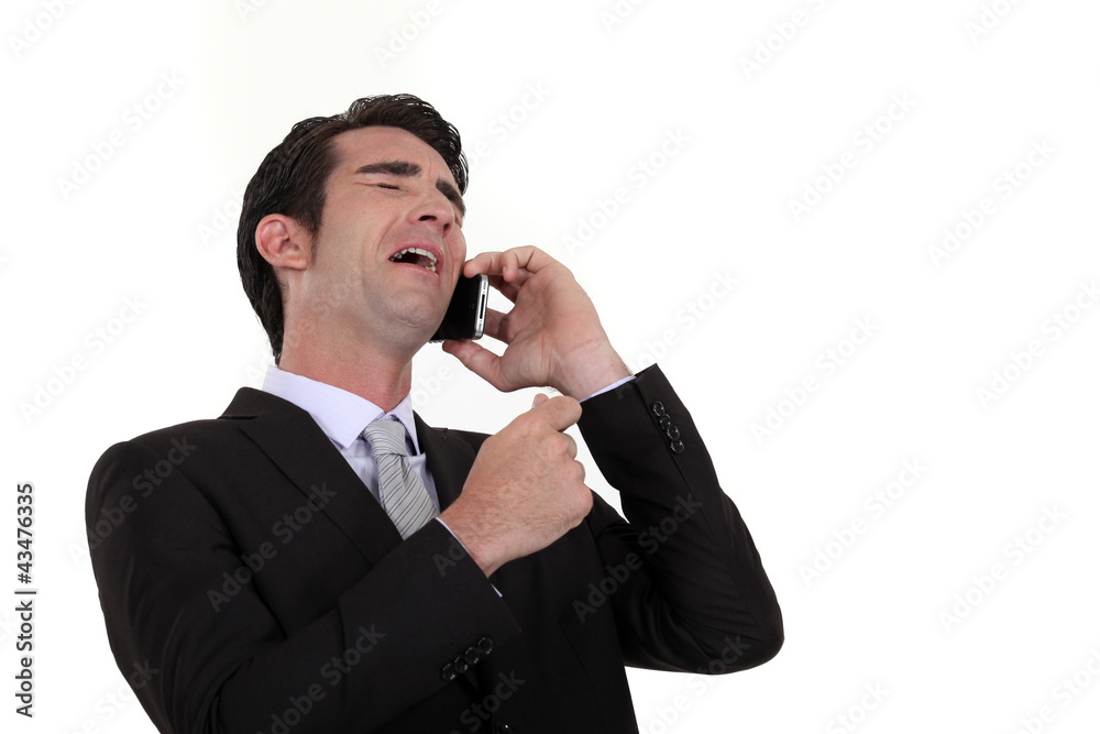 Businessman laughing during telephone call