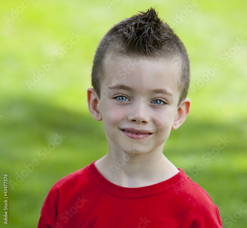 Young boy in grass at the park