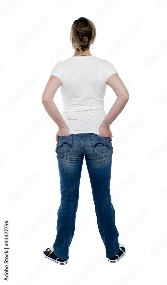 Back view of trendy woman with hands in pocket Back view of trendy woman with hands in pocket
