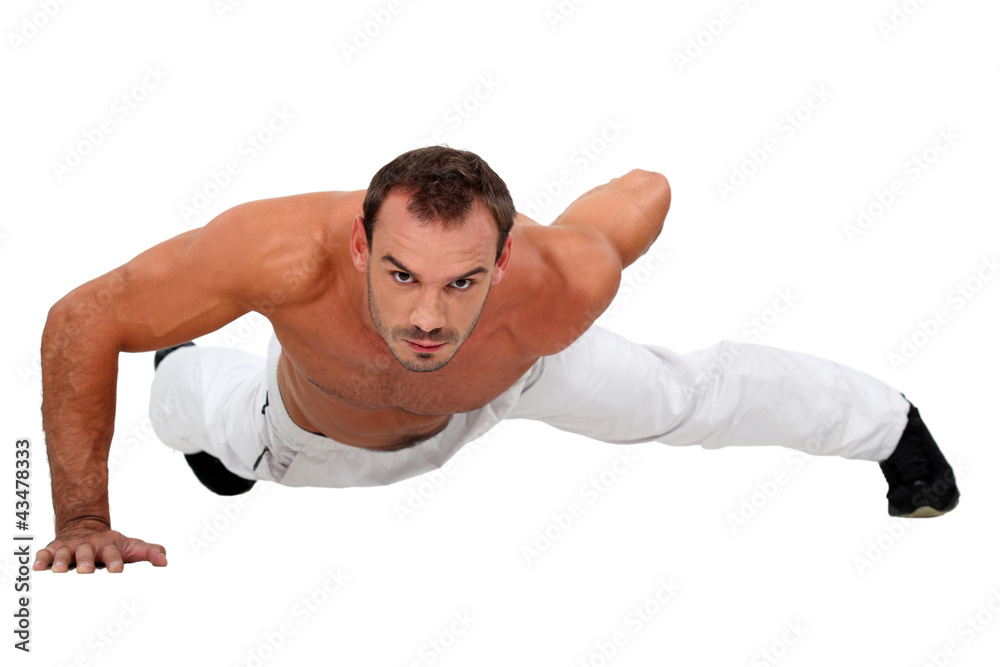 Man doing one-armed push-up Man doing one-armed push-up