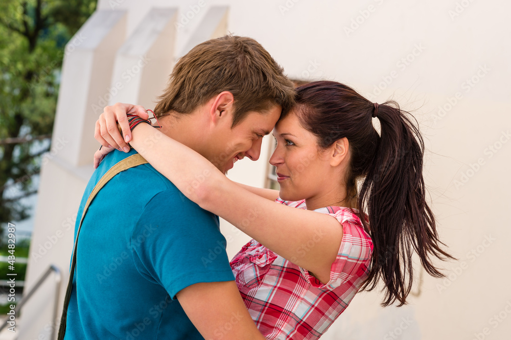 Happy dating couple embracing outdoors Happy dating couple embracing outdoors