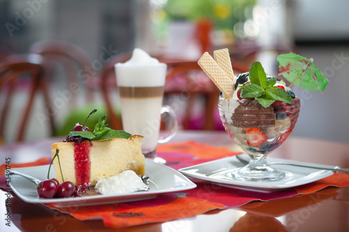 Ice cream, cake and coffee at restaurant table
