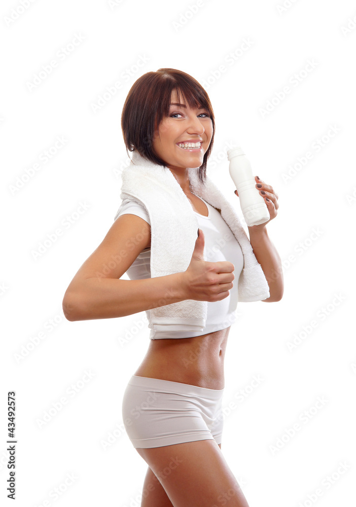 A young and fit Caucasian woman holding thumbs up and a bottle A young and fit Caucasian woman holding thumbs up and a bottle