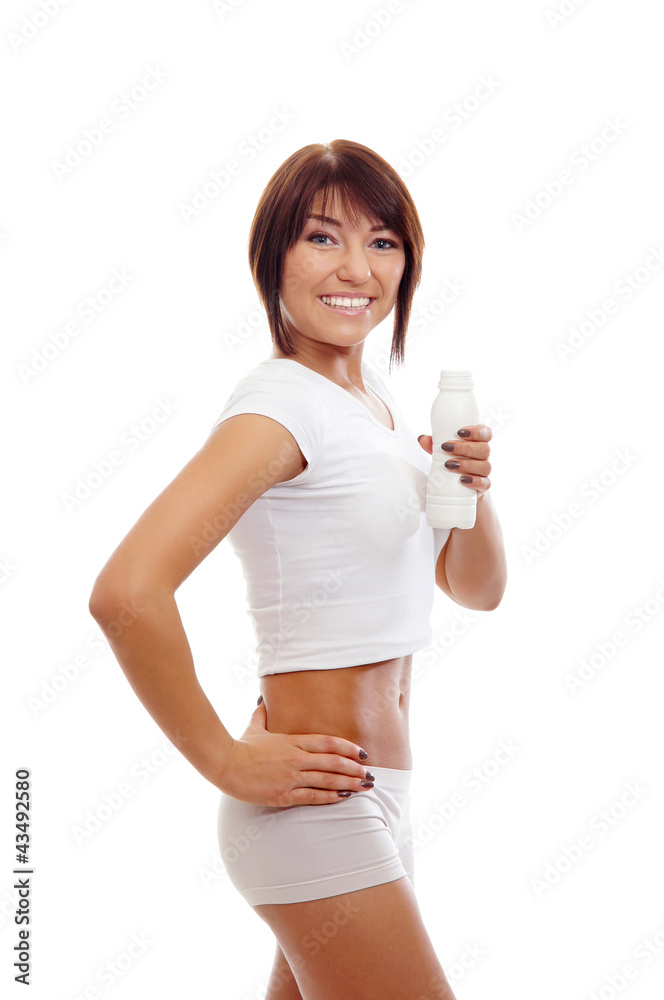 A young and fit brunette Caucasian woman holding a bottle A young and fit brunette Caucasian woman holding a bottle
