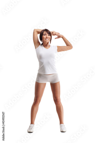A young and sporty brunette woman doing a stretching exercise