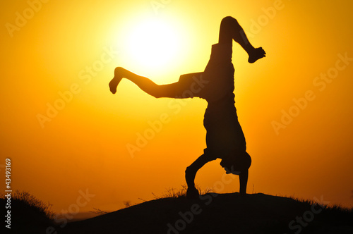 Man in the sunset jump and shout