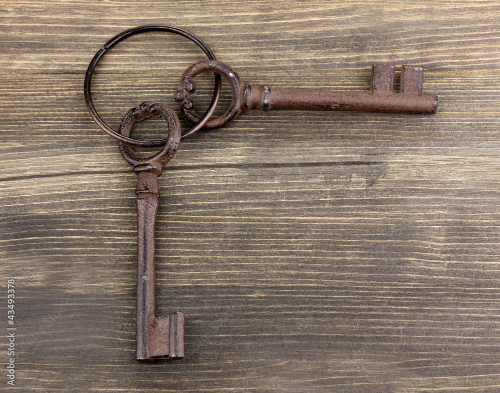 a bunch of antique keys on wooden background a bunch of antique keys on wooden background