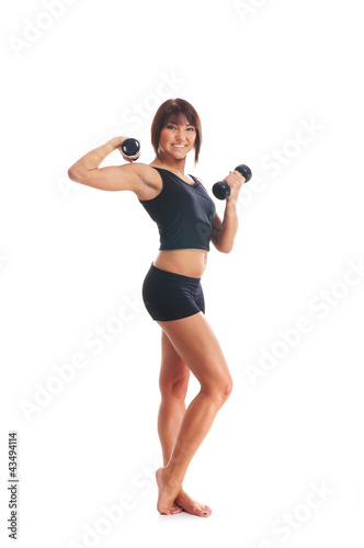 A young and fit brunette woman doing a workout with dumbbells