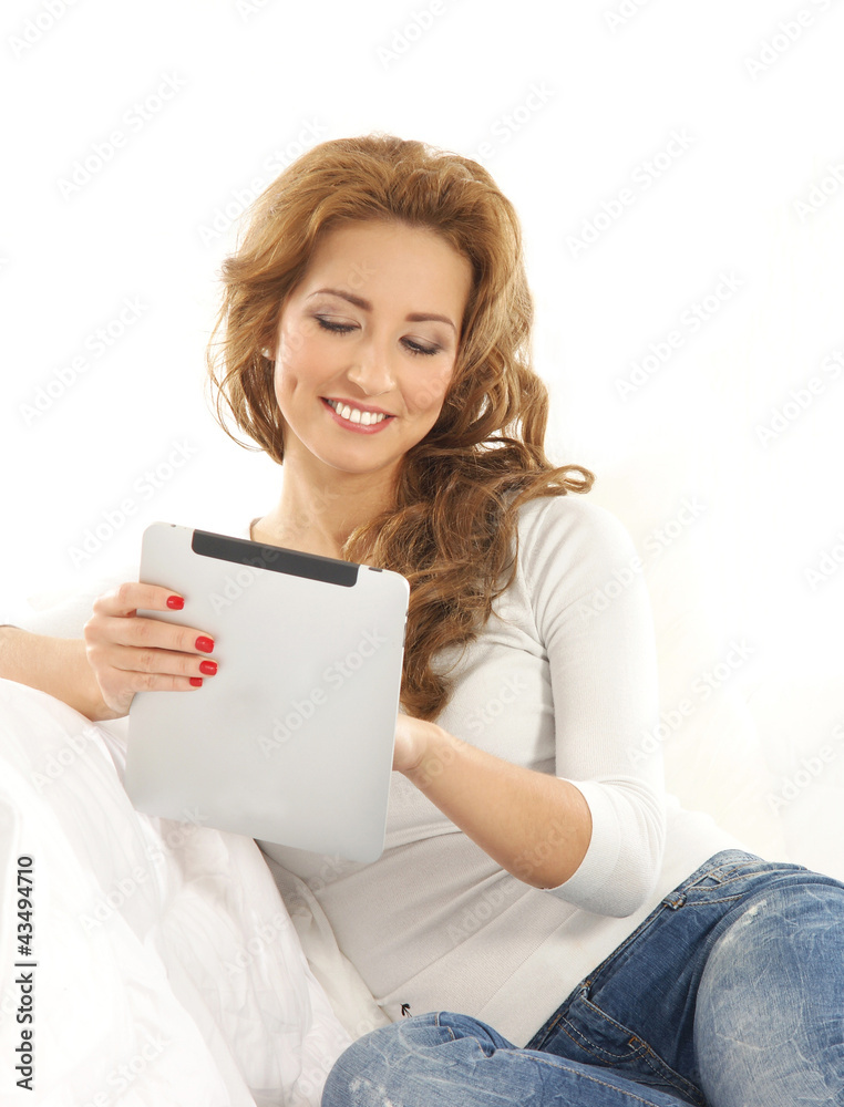 A young Caucasian woman relaxing on a white sofa A young Caucasian woman relaxing on a white sofa