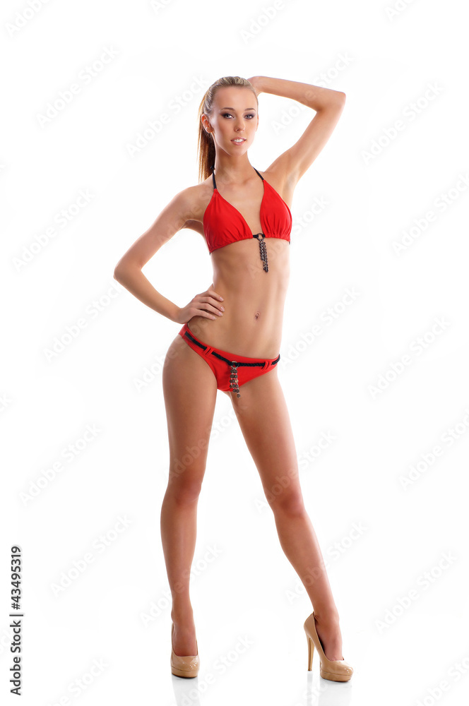 A young blond Caucasian woman posing in a red swimsuit A young blond Caucasian woman posing in a red swimsuit
