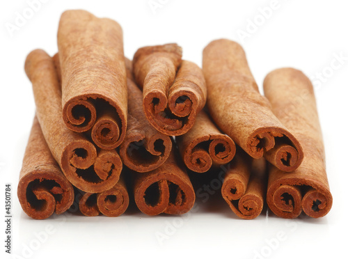 Cinnamon sticks spice isolated over white background. photo