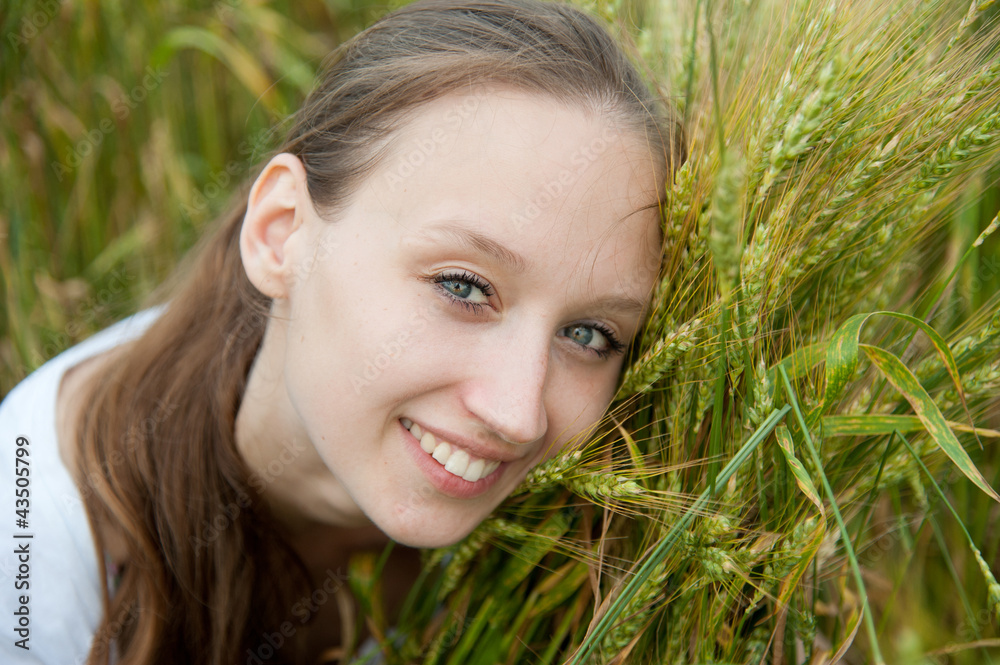 Beautiful woman smiles in a wheat field Beautiful woman smiles in a wheat field