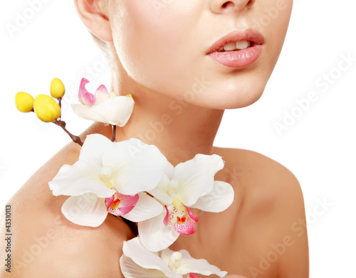 A young woman with orchid  isolated on white background