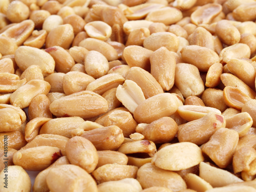 Close up of fried, peeled and salted peanuts.